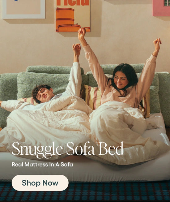 Two people lying on a sofa bed with the text 'Snuggle Sofa Bed' and 'Shop Now'.