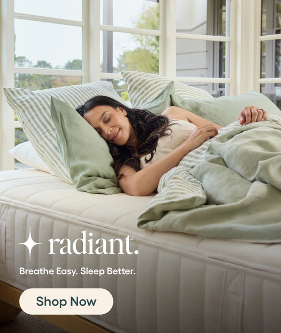 Woman lying on a bed with green bedding and pillows, promoting 'radiant' brand.