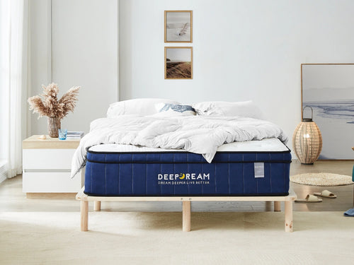 Medium firm mattress on wooden bed with white bedding.
