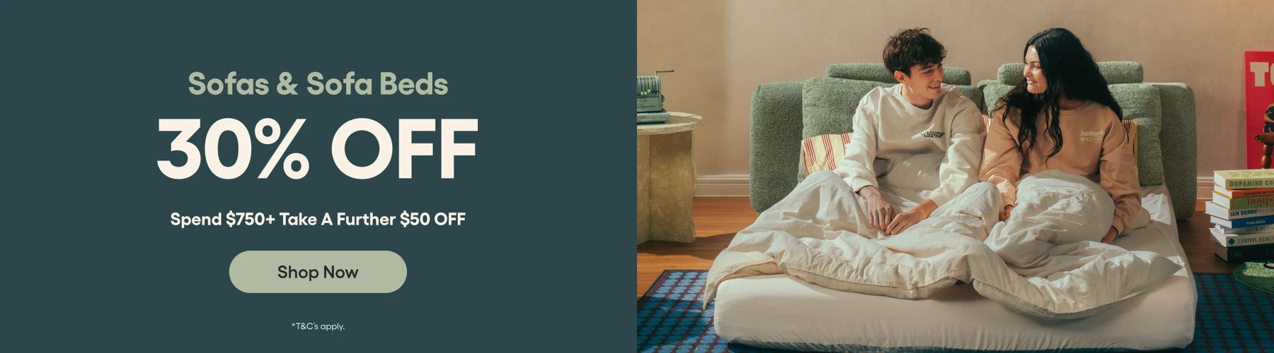 Promotional banner for sofas and sofa beds with a couple sitting on a couch in a living room.
