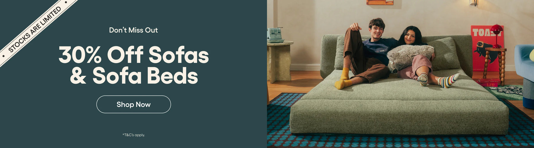 Promotional banner for 30% off sofas and sofa beds with a couple on a gray sofa.
