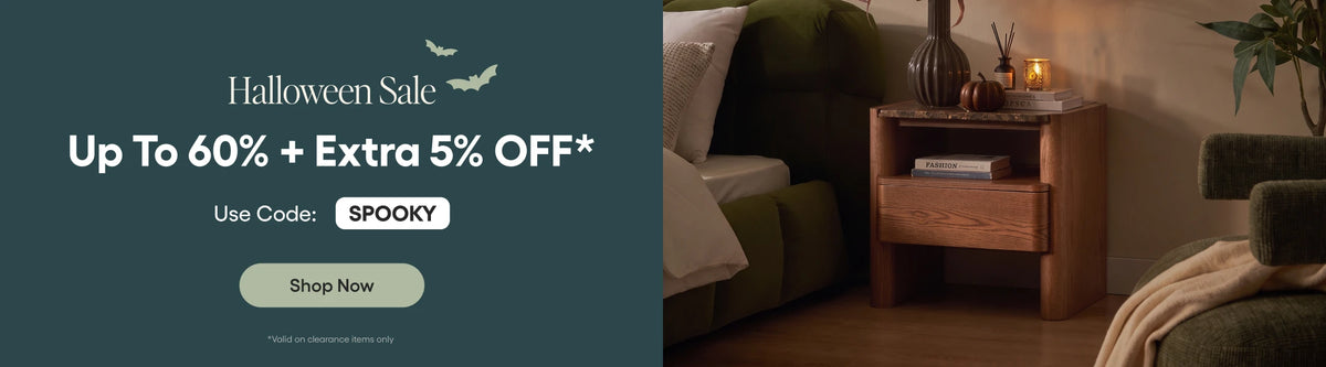 Promotional banner for Halloween Sale with text reading 'Up To 60% + Extra 5% Off*' and a code 'SPOOKY', alongside a styled interior scene showing a wooden nightstand, green sofa, and candlelit room.