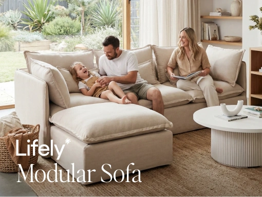 Family sitting on a beige modular sofa in a living room with 'Lively Modular Sofa' branding.