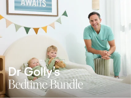 A man in light teal medical scrubs sits on a stool next to a baby crib in a bright nursery, with two children in the crib. Large text overlay reads 'Dr Golly's Bedtime Bundle'.