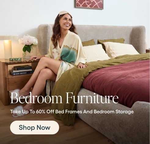 Woman sitting on a bed in a bedroom with promotional text for bedroom furniture.