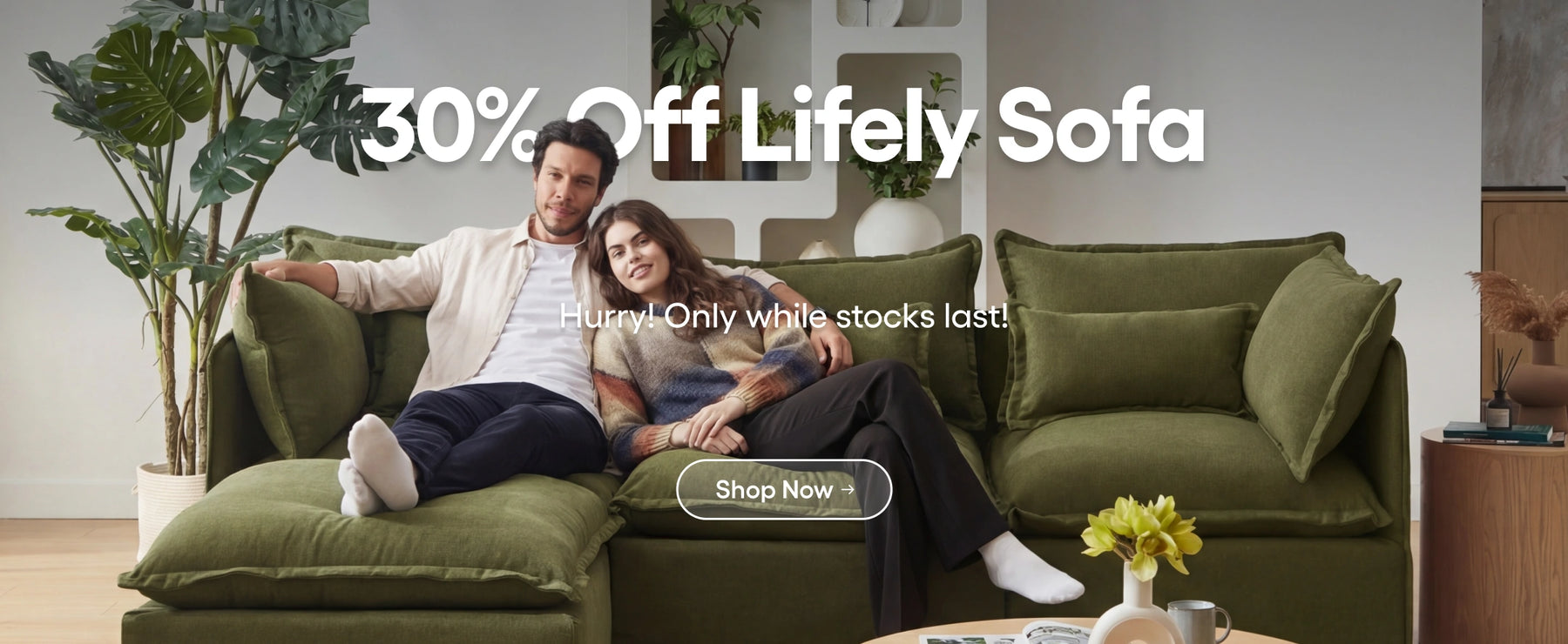 Couple sitting on a green sofa with promotional text overlay