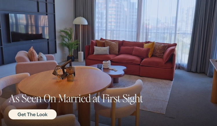 Living room with red sofa, wooden table, and decor elements.