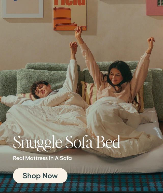 Two people lying on a sofa bed with the text 'Snuggle Sofa Bed' and 'Shop Now' displayed.