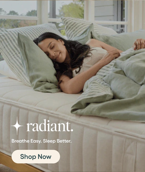 Woman lying on a bed with green bedding, featuring the 'radiant' brand.