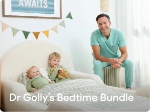 A smiling man in light teal medical scrubs sits beside a bed with two children in a bright bedroom. The text 'Dr Golly's Bedtime Bundle' appears across the bottom.